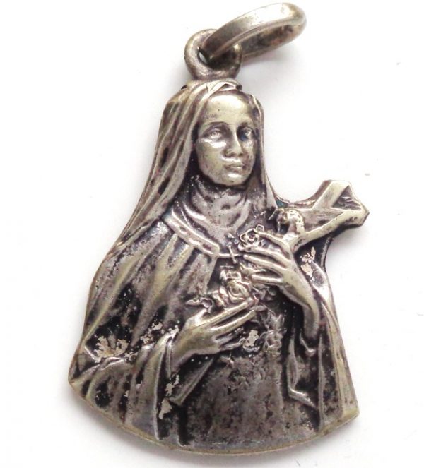 ancient figurine shaped medal saint therese rain of roses