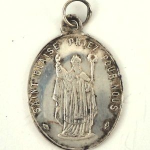 "Solid silver medal featuring Saint Blaise with the inscription 'Saint Blaise Priez Pour Nous.'"