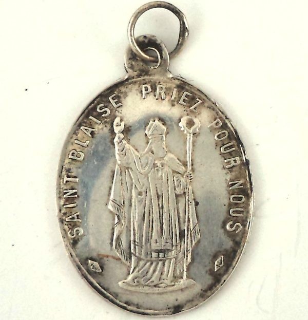 "Solid silver medal featuring Saint Blaise with the inscription 'Saint Blaise Priez Pour Nous.'"