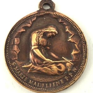 Antique bronze medal of Saint Mary Magdalene in prayer with a cross and skull, engraved by Ludovic Penin.