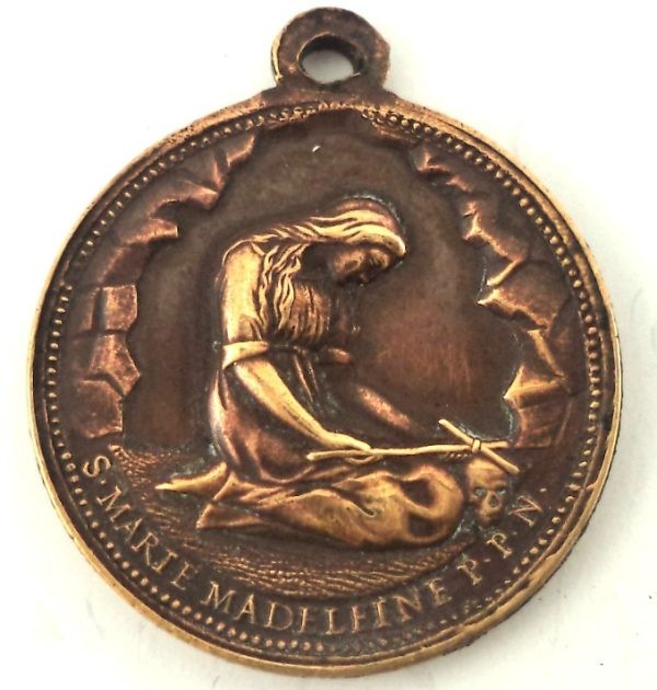 Antique bronze medal of Saint Mary Magdalene in prayer with a cross and skull, engraved by Ludovic Penin.