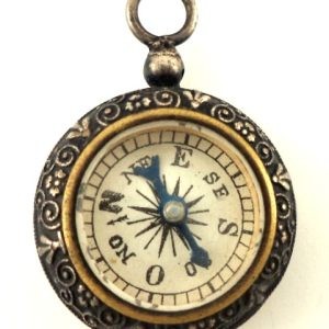 Antique silver-plated compass pendant with a functional compass and detailed floral designs