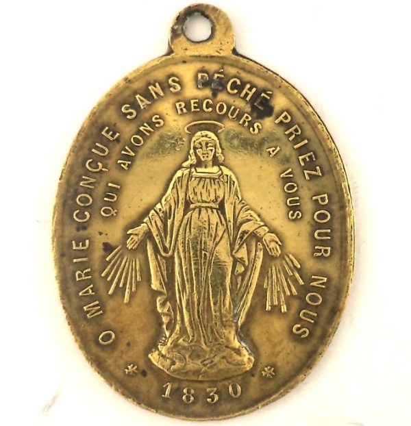 Antique bronze Miraculous Medal front featuring Virgin Mary and prayer inscription.