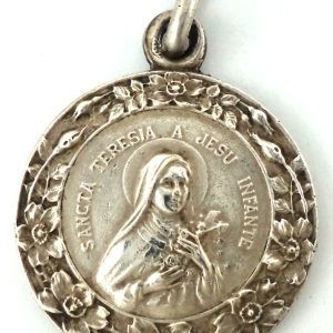 Silver-plated medal of Saint Therese of the Child Jesus with a floral border