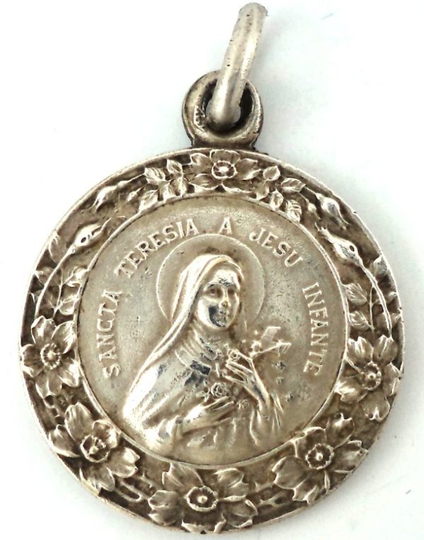 Silver-plated medal of Saint Therese of the Child Jesus with a floral border