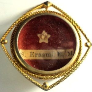 Antique ex-ossibus reliquary of Saint Erasmus with gold-plated frame and glass cover.