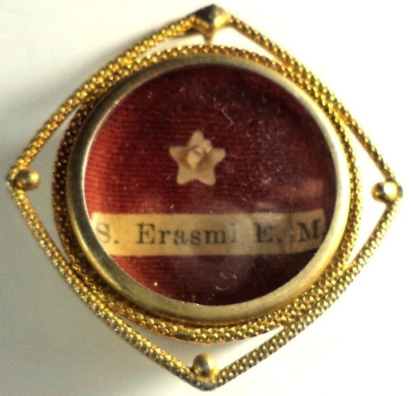 Antique ex-ossibus reliquary of Saint Erasmus with gold-plated frame and glass cover.