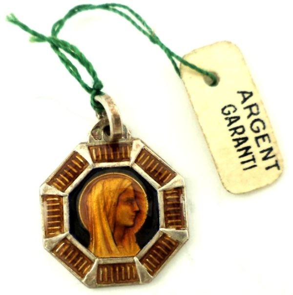 Silver art deco medal with a portrait of the Holy Virgin Mary surrounded by orange and brown enamel design