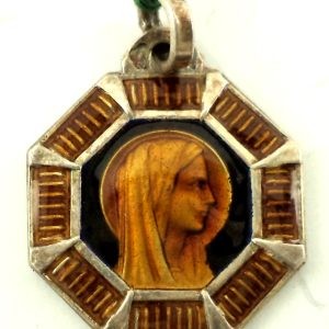 Silver art deco medal with a portrait of the Holy Virgin Mary surrounded by orange and brown enamel design