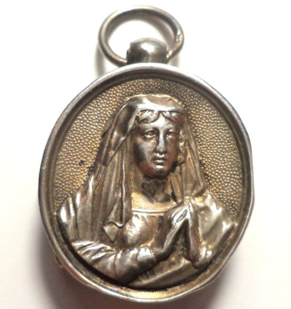 Antique silver locket reliquary containing a relic of Saint Mary Magdalene.