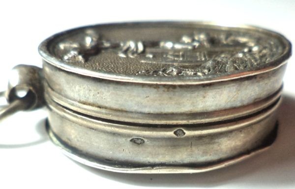 Antique silver locket reliquary containing a relic of Saint Mary Magdalene.