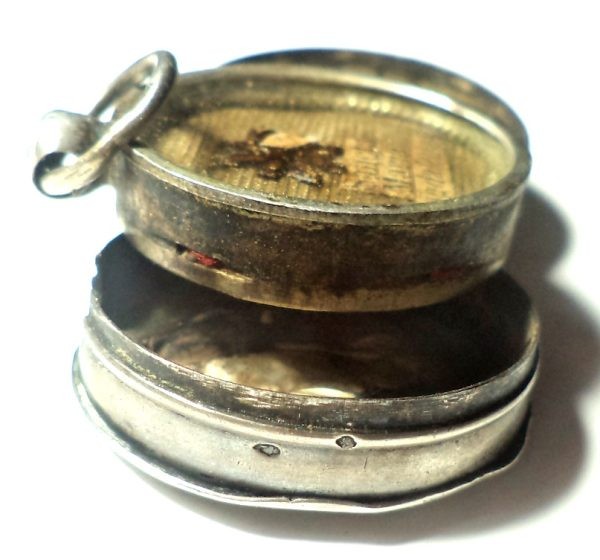 Antique silver locket reliquary containing a relic of Saint Mary Magdalene.