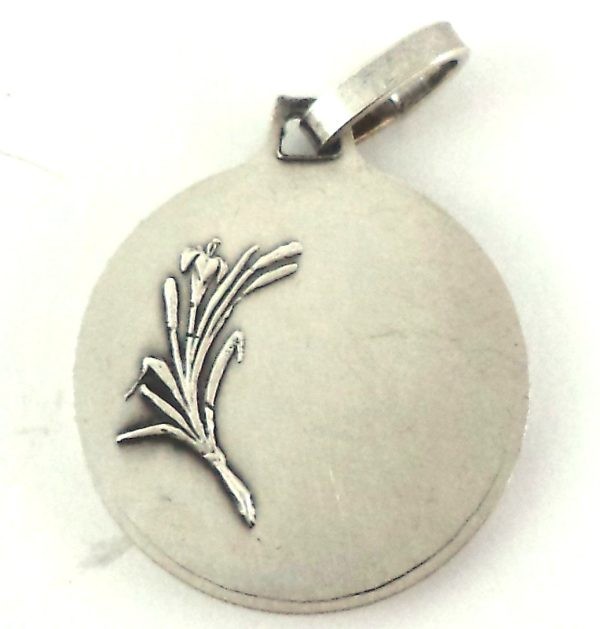 Reverse side of vintage silver-plated Saint Martin medal pendant with lily motif