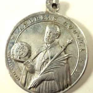 Front view of an antique Saint Andreas Bobola medal pendant in aluminium, featuring the saint holding the IHS symbol.