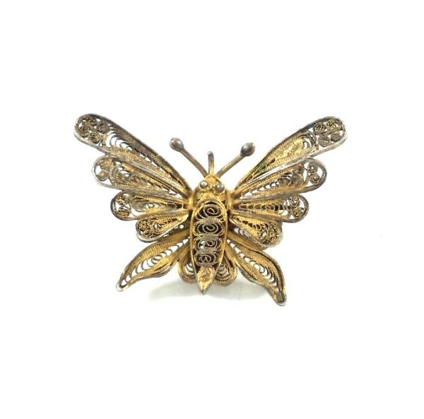 Antique butterfly brooch crafted in gilded filigree, showcasing intricate craftsmanship and a delicate butterfly design.