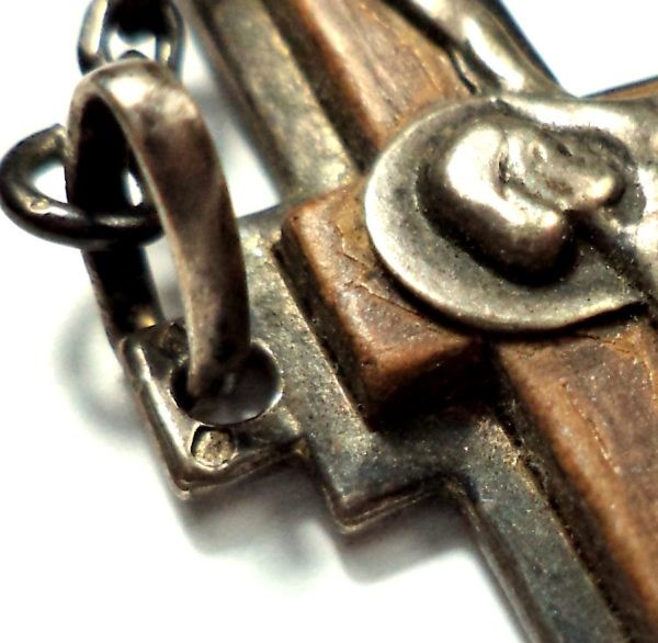 Close-up of antique rosary with brown banded agate beads, silver crucifix, and central medal.