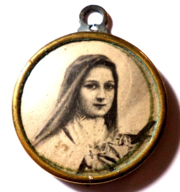 Antique sepia medal pendant featuring Saint Therese of Infant Jesus.