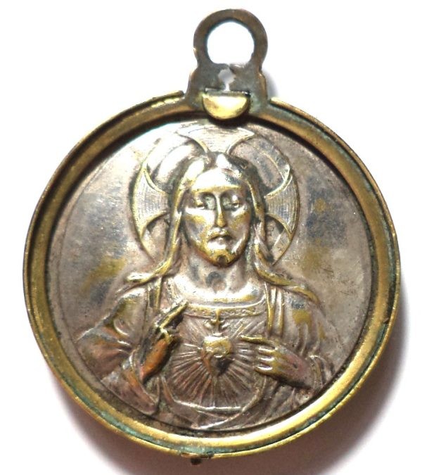 Silver-plated Sacred Heart of Jesus on the reverse of an antique medal.