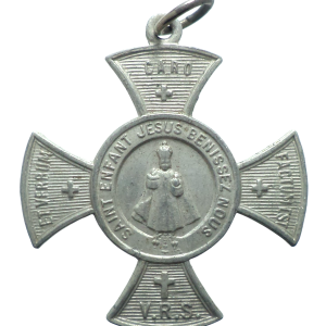 Antique aluminium cross medal dedicated to the Infant Jesus of Prague with devotional inscriptions.